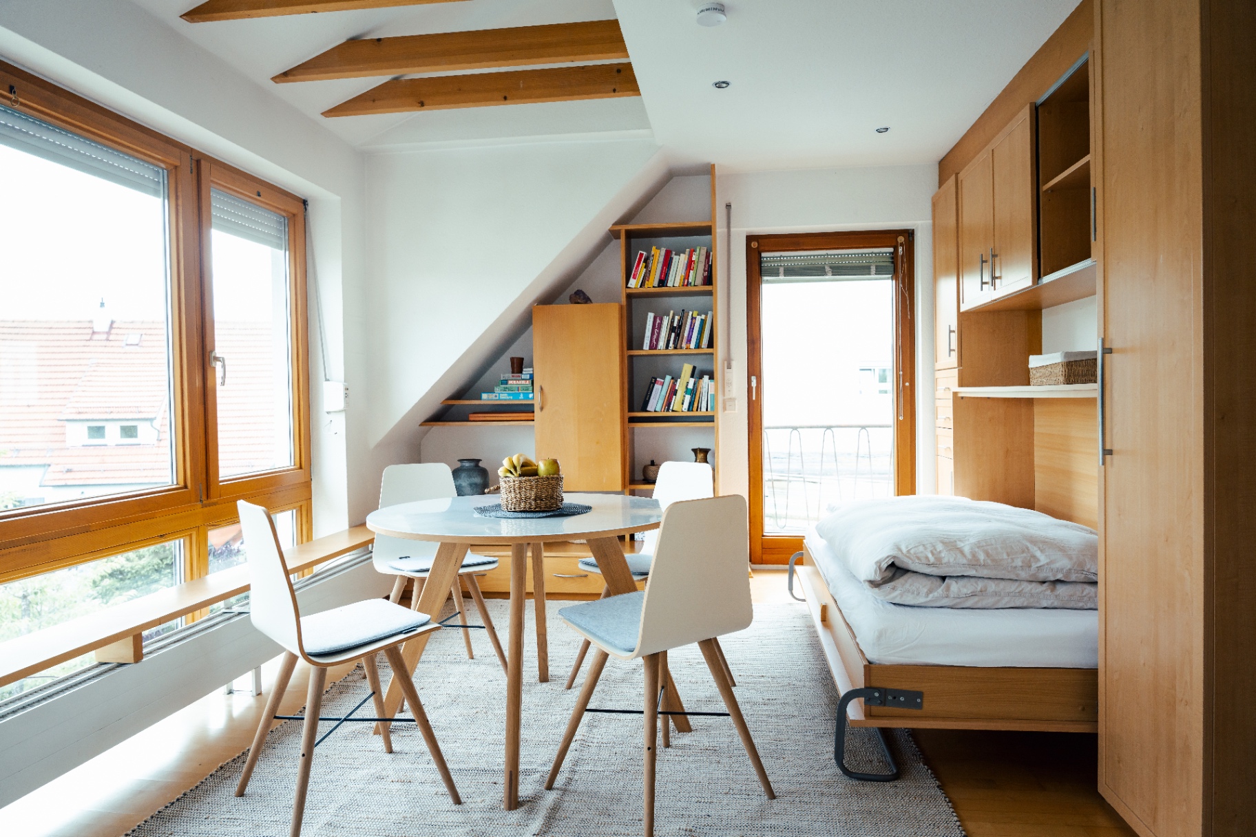 Bright apartment interior with dining area and wooden details